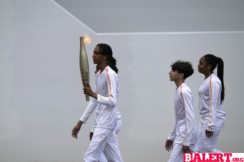 Olympic Flame Shines Bright on Bastille Day in Paris